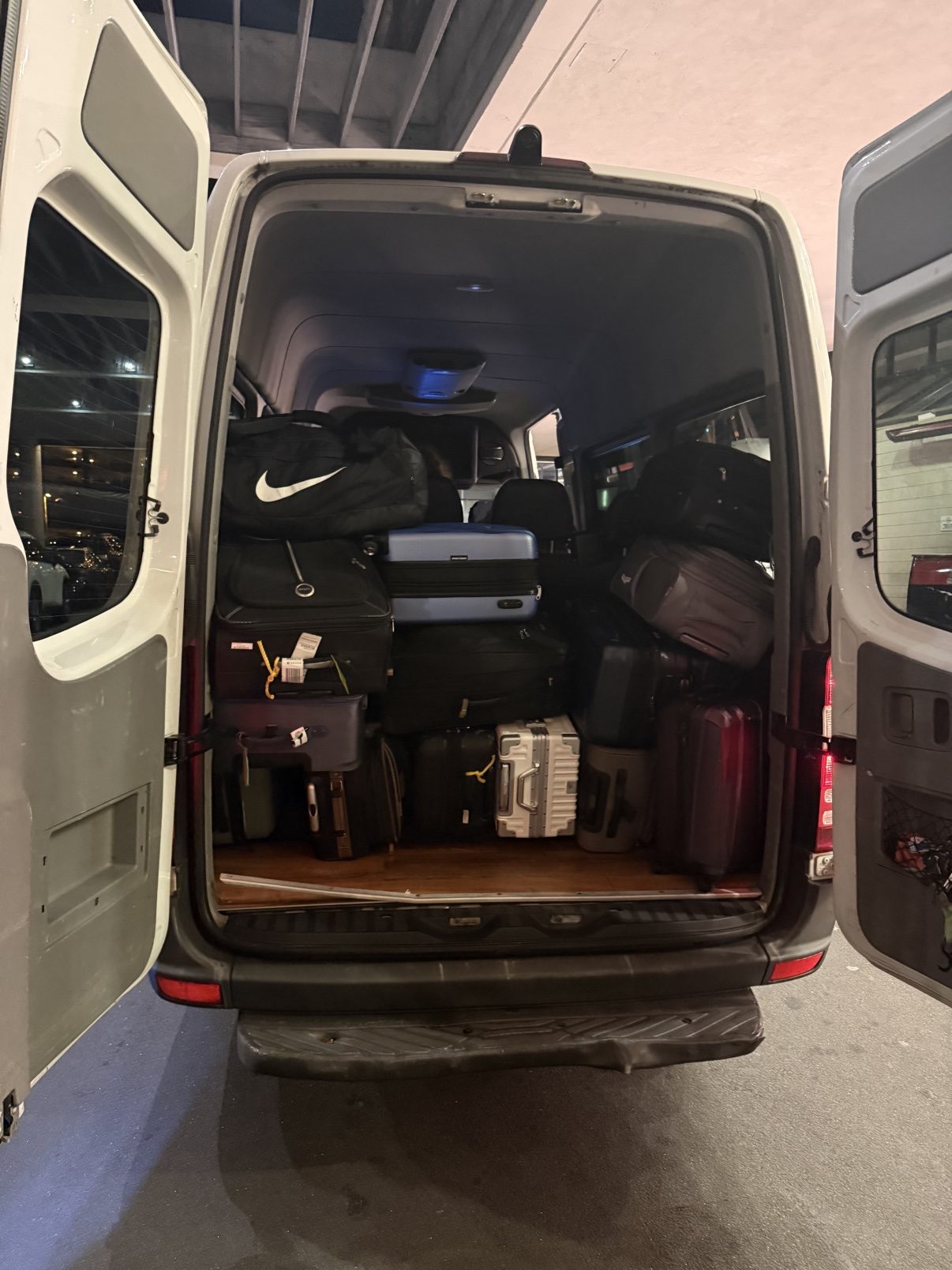 Sprinter van cargo area packed with passenger luggage
