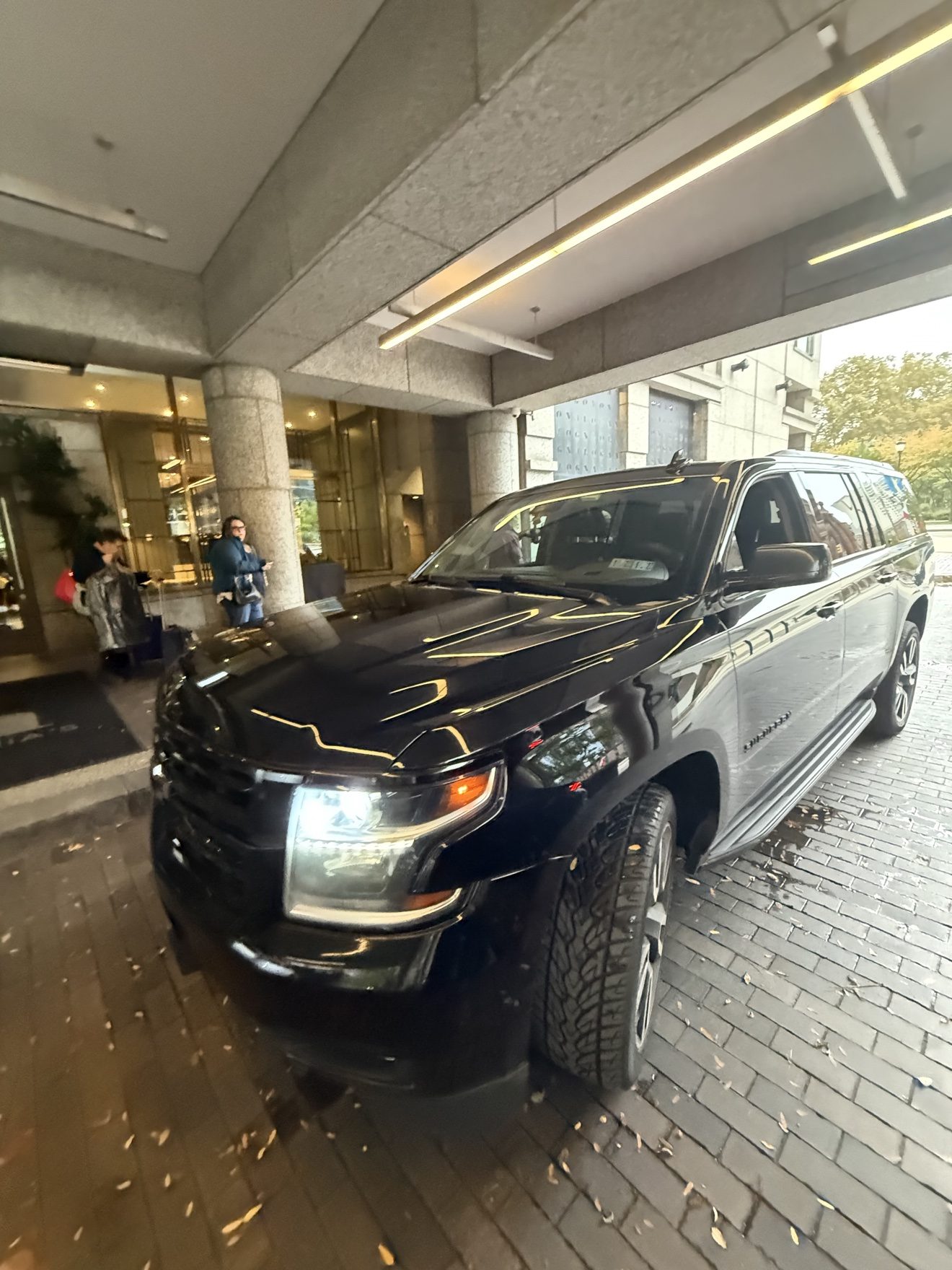 Black SUV waiting in front of a hotel entrance