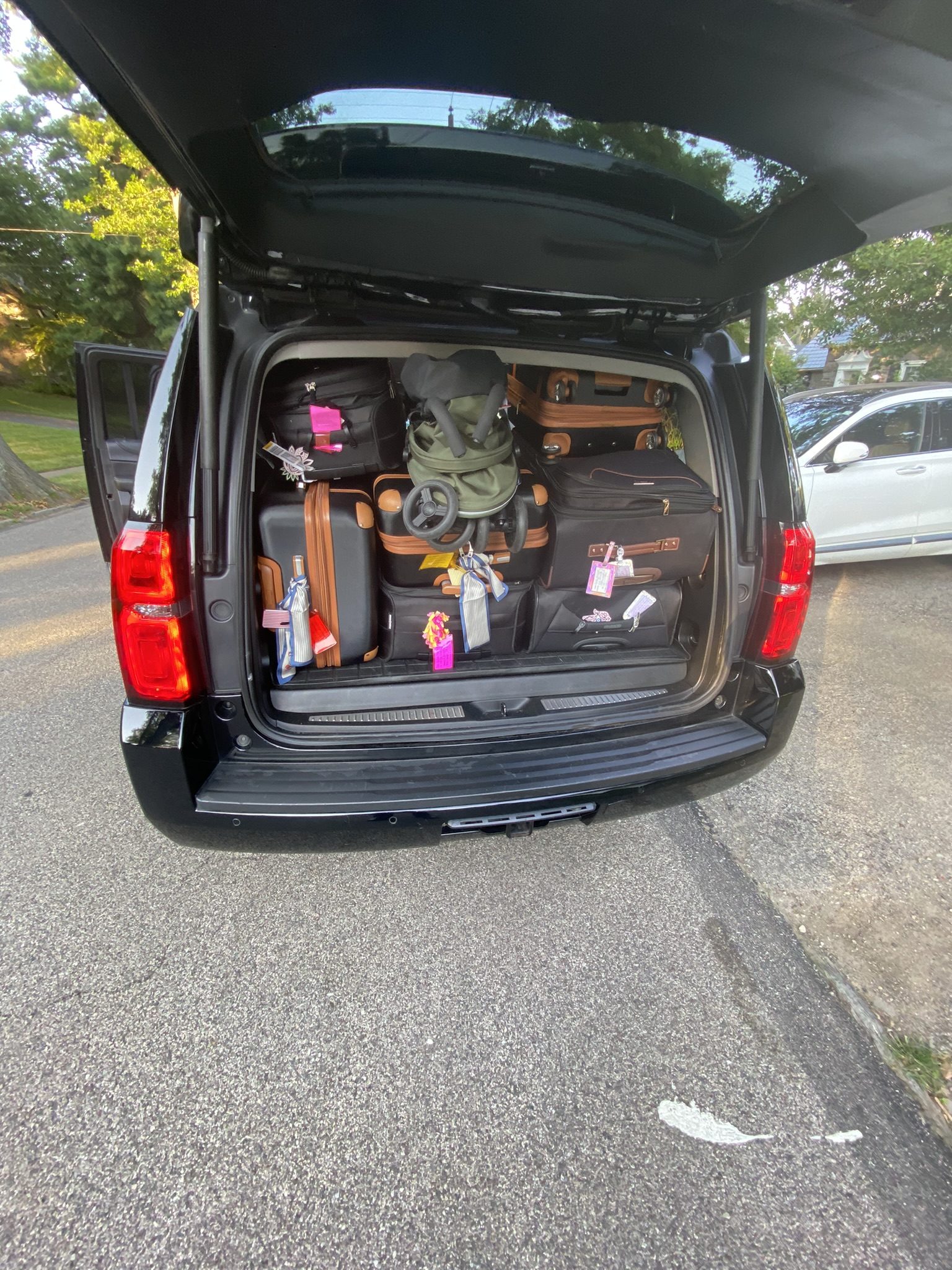 SUV cargo area packed with luggage for airport travel